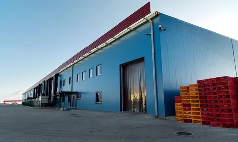 Blue industrial building with completed wall and roof envelope