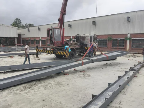 Steel members being positioned during frame erection